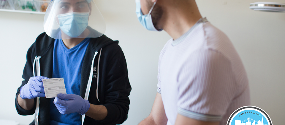 clinic worker showing card to patient